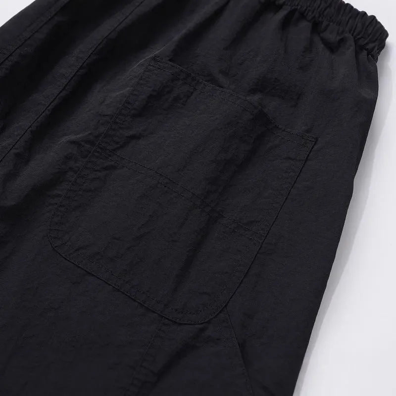 Black paratrooper pants with elastic waist, three-dimensional cutting, and baggy fit