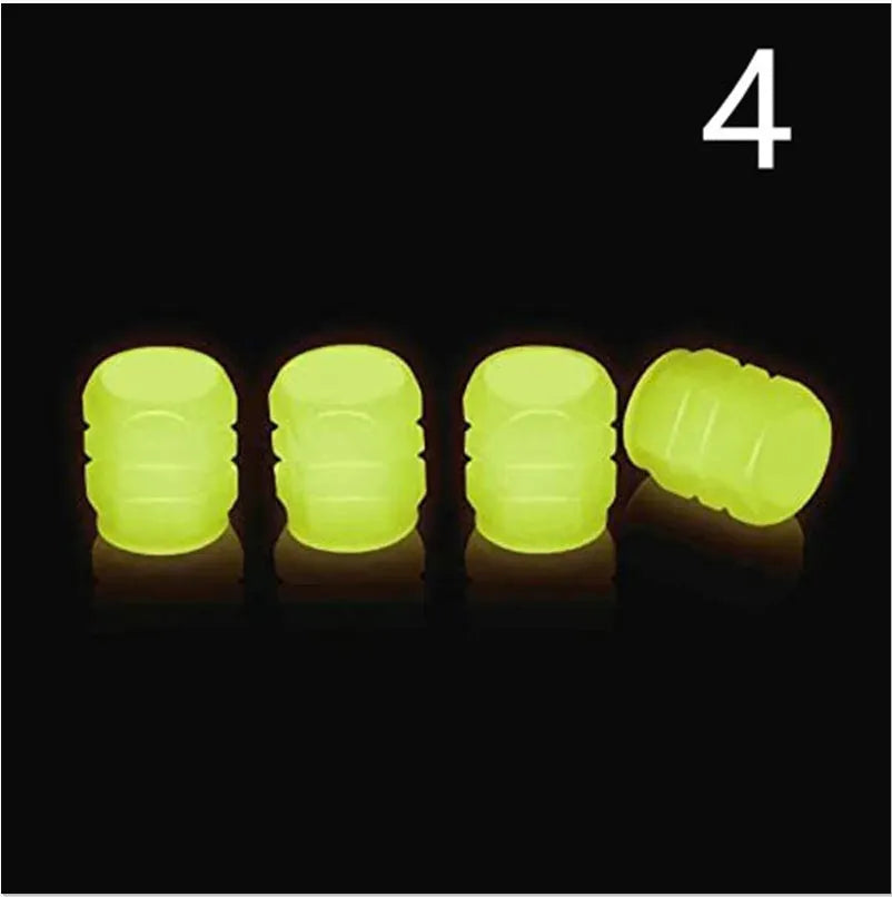 Pack of green and blue luminous rubber tyre valve caps on a car tyre valve.
