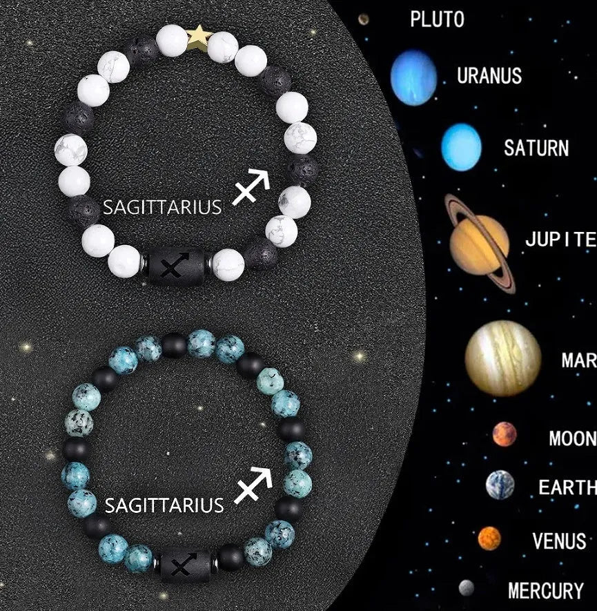 Two natural stone beaded zodiac bracelets with adjustable strings on wooden surface