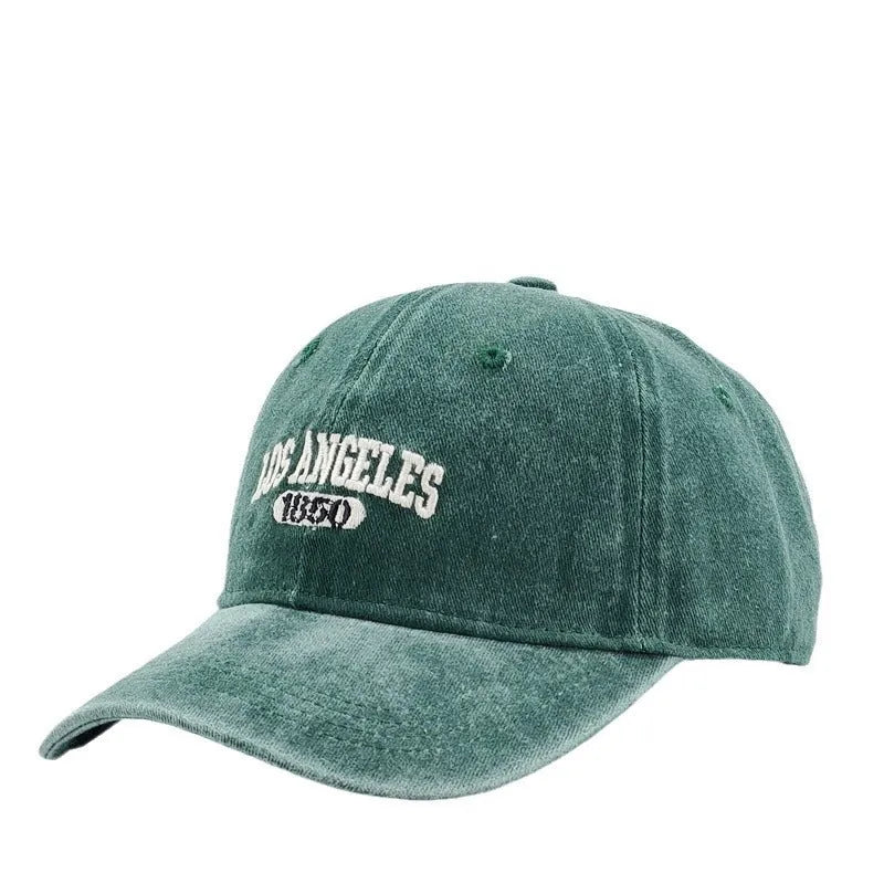 Adult personalised embroidered peaked cap in beige with adjustable strap and distressed lettering.