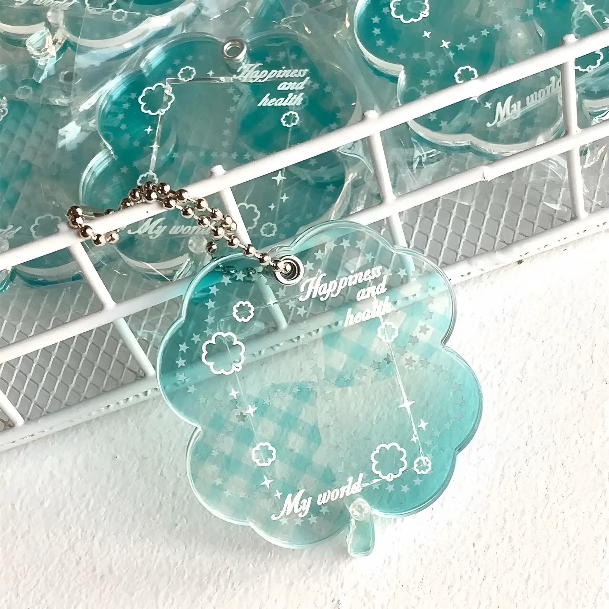 Acrylic four-leaf clover mobile phone pendant keychain in blue, green, and mint colours
