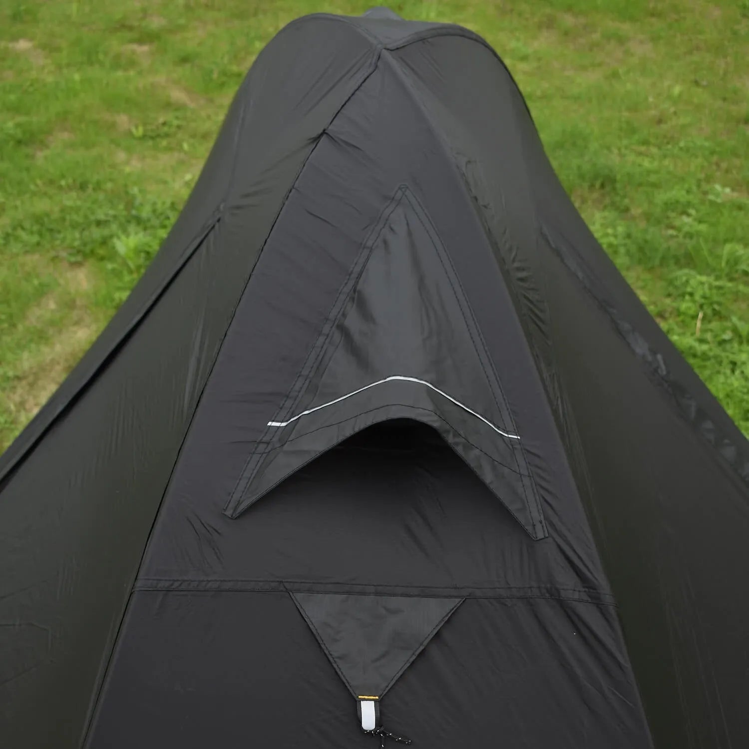 Black single person double account tent with aluminium poles set up outdoors