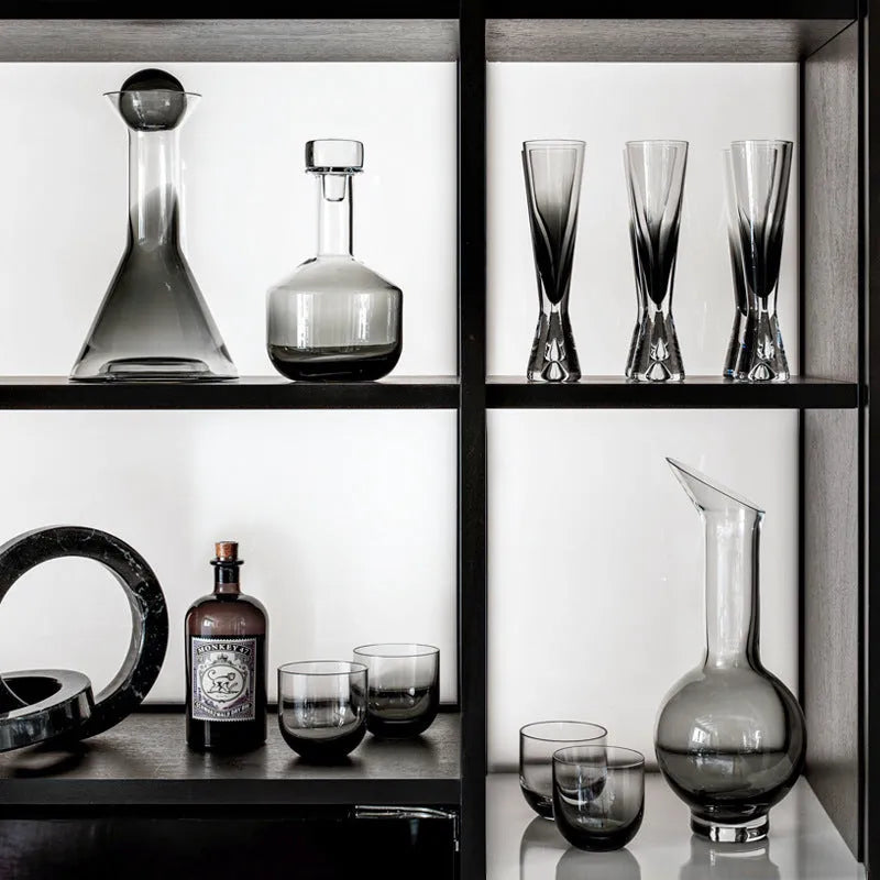Glass wine accessories set with champagne flutes red wine glasses ice bucket and stainless steel ornaments on table