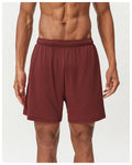 Men's double-layer quick-drying running shorts in brick red colour on a mid-waist model.