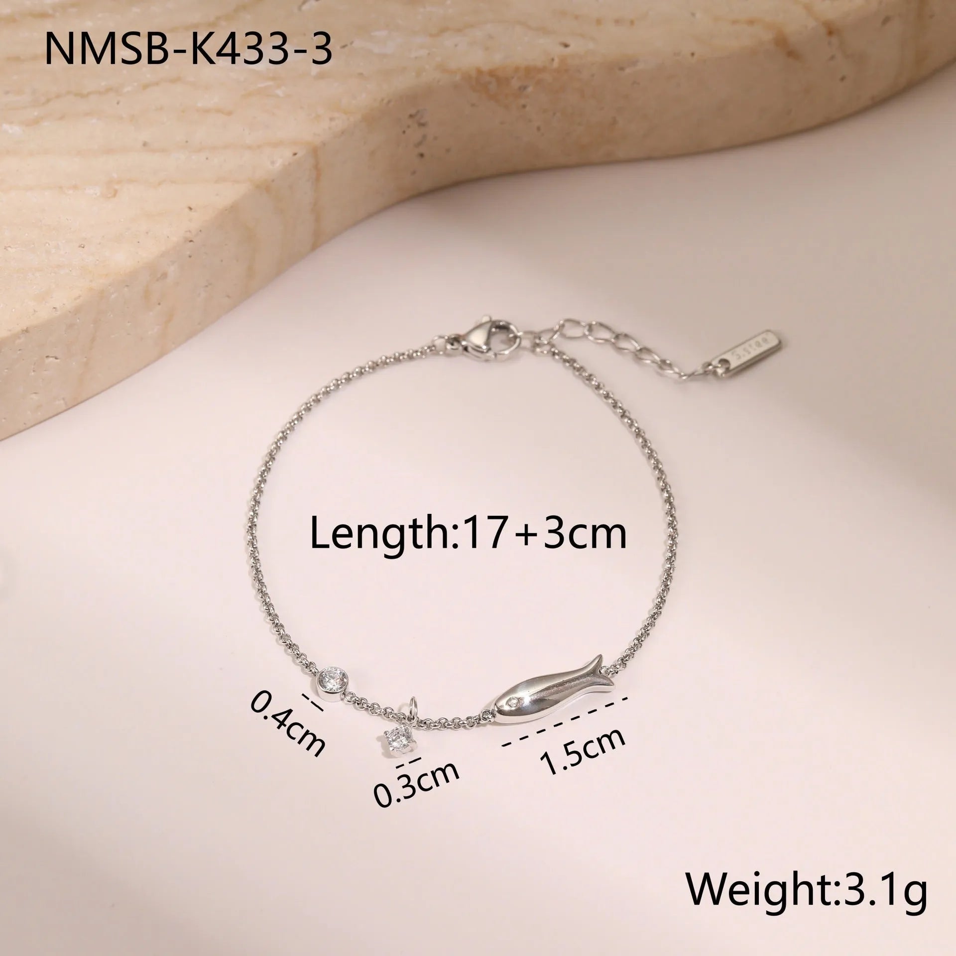 Gold plated stainless steel bracelet with a detailed zircon star pendant on a woman's wrist.
