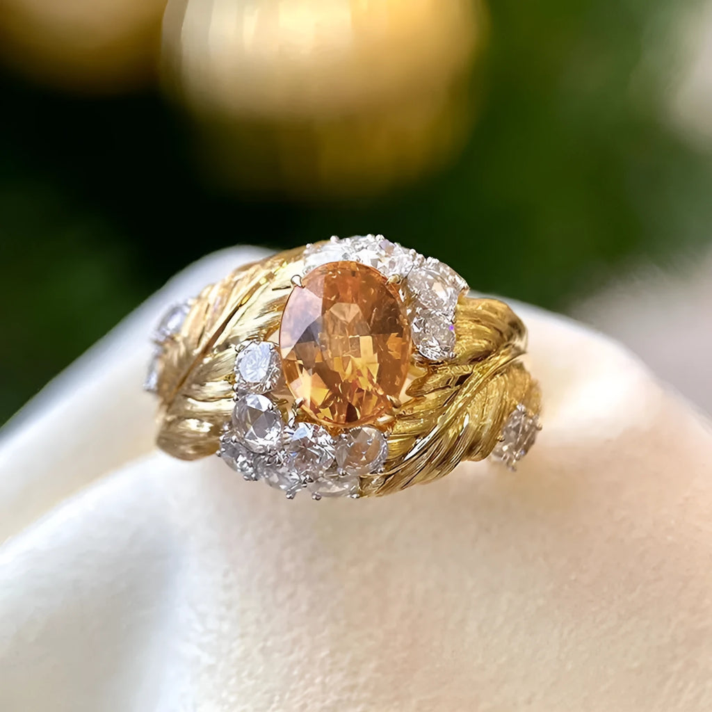 Gold-colour copper feather ring with embossed design and yellow zircon inlay on geometric shape