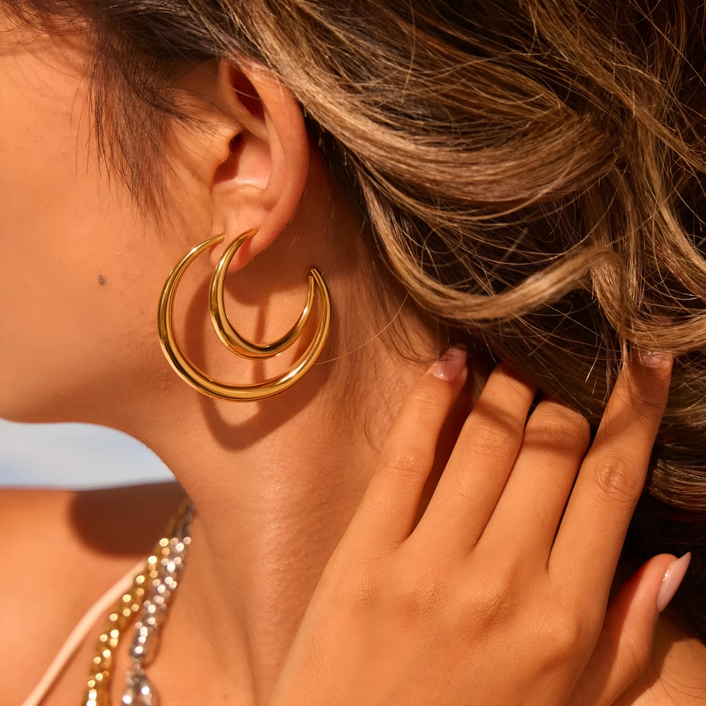 Simple round stainless steel hoop earrings for women in gold and steel colours, available in two sizes.