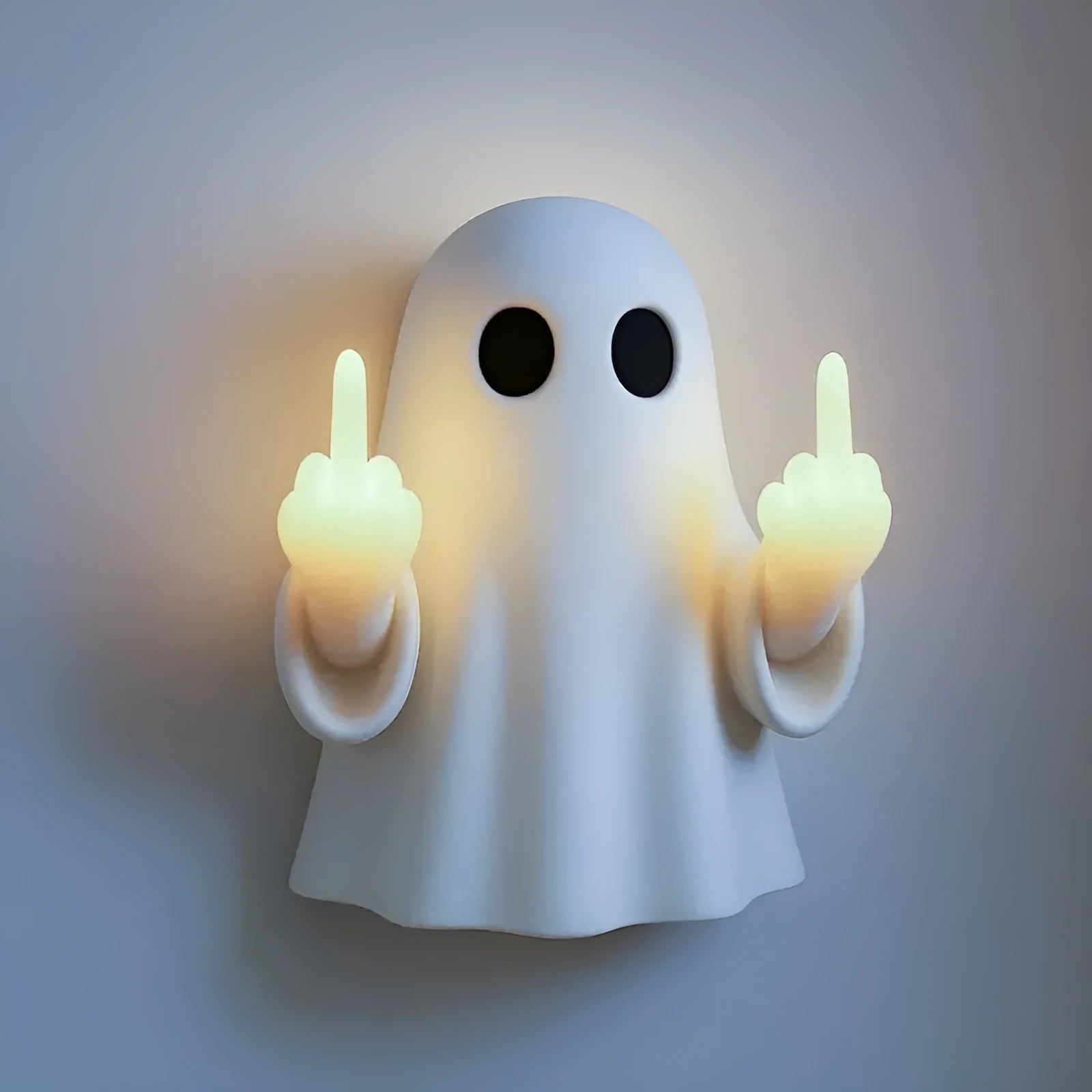 Small white modern ghost statue night light for Halloween decoration on a table.