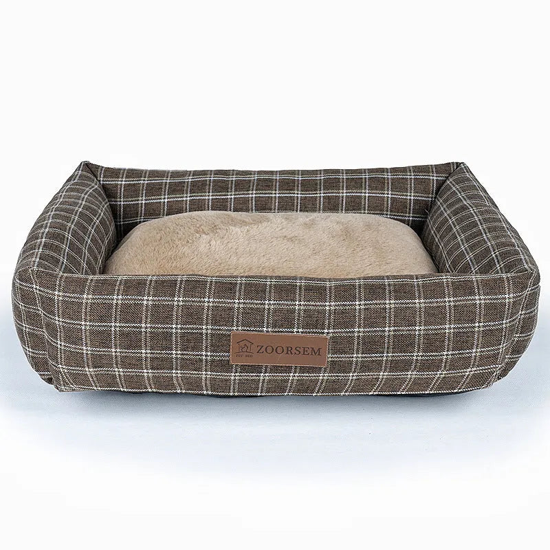 Grey plaid square cloth dog bed for medium-sized dogs on a wooden floor.