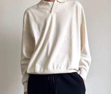 Man's pure wool polo sweater with a lapel collar in a loose fit, shown in navy blue.