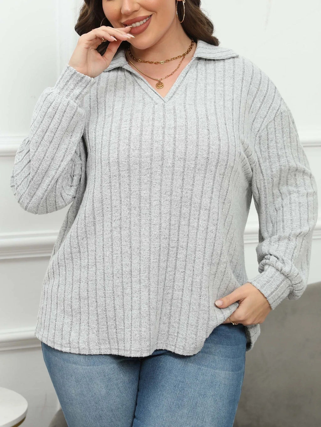 Women's plus size grey polo collar fleece shirt with lantern sleeves on a hanger.