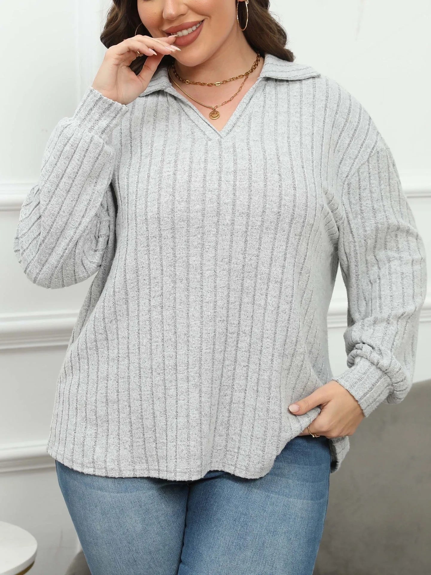Women's plus size grey polo collar fleece shirt with lantern sleeves on a hanger.