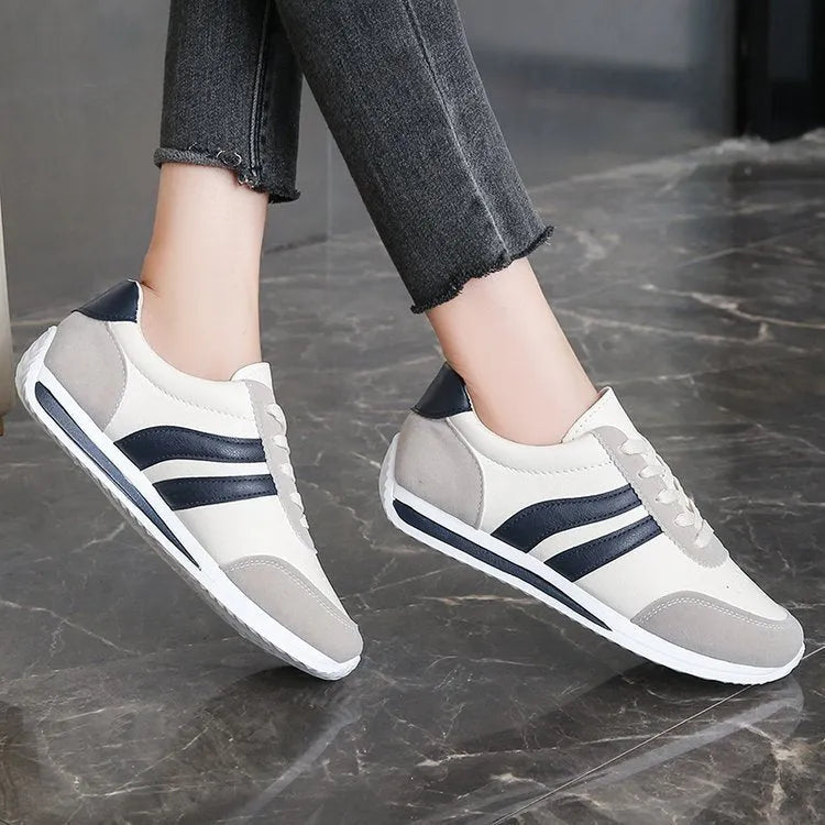 Red and blue lace-up low-top running sneakers with mesh upper and rubber sole on a white background.