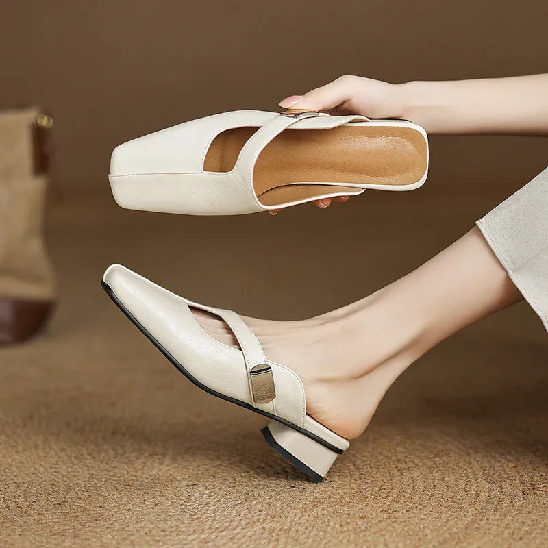 Pair of square-toe casual slippers with a low heel on a rubber sole, shown in a solid colour.