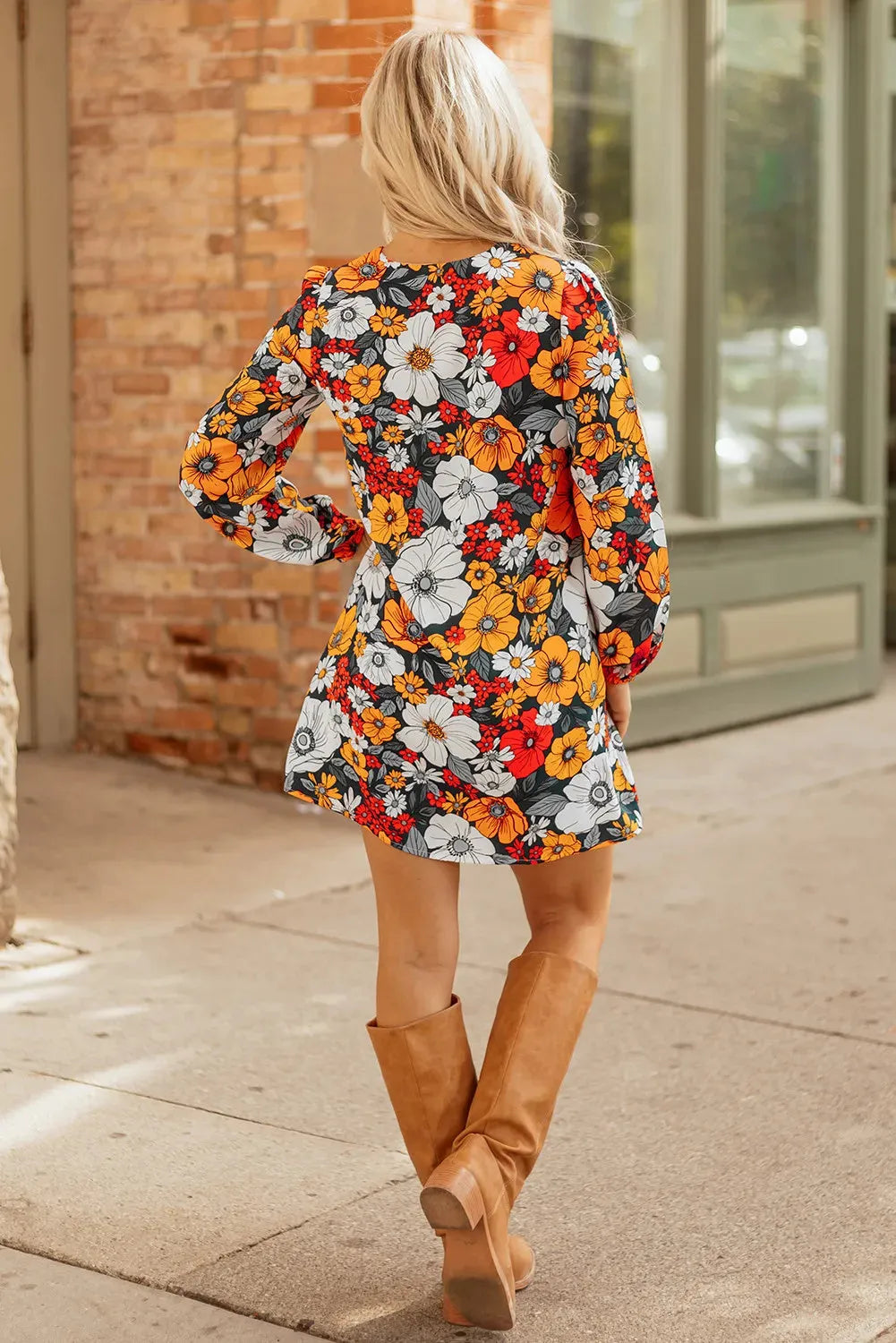 Orange floral print striped lace V-neck long sleeve mini dress on a hanger