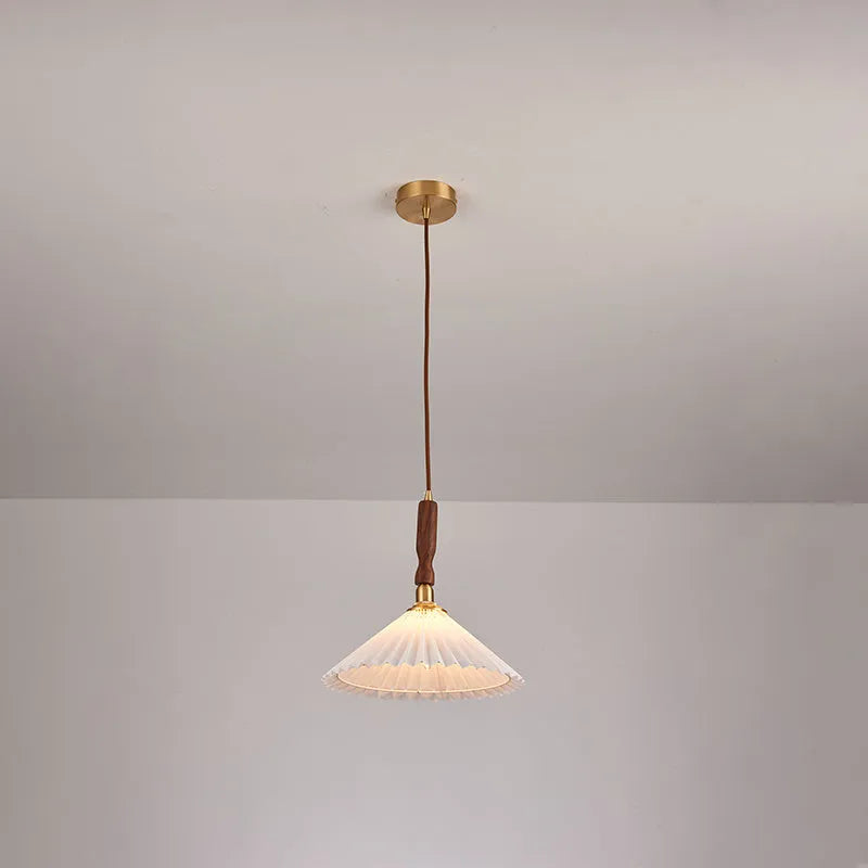 American retro style adjustable wall lamp in walnut wood with a fabric shade, mounted beside a bed.