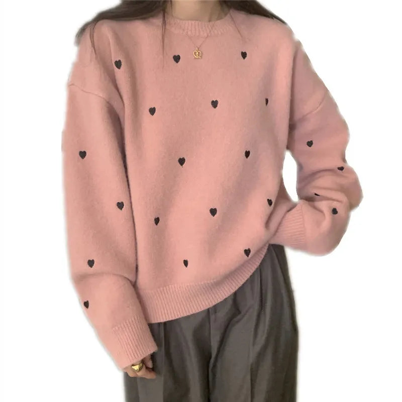 Women's loose fit acrylic pullover sweater with embroidered love pattern in milky white.