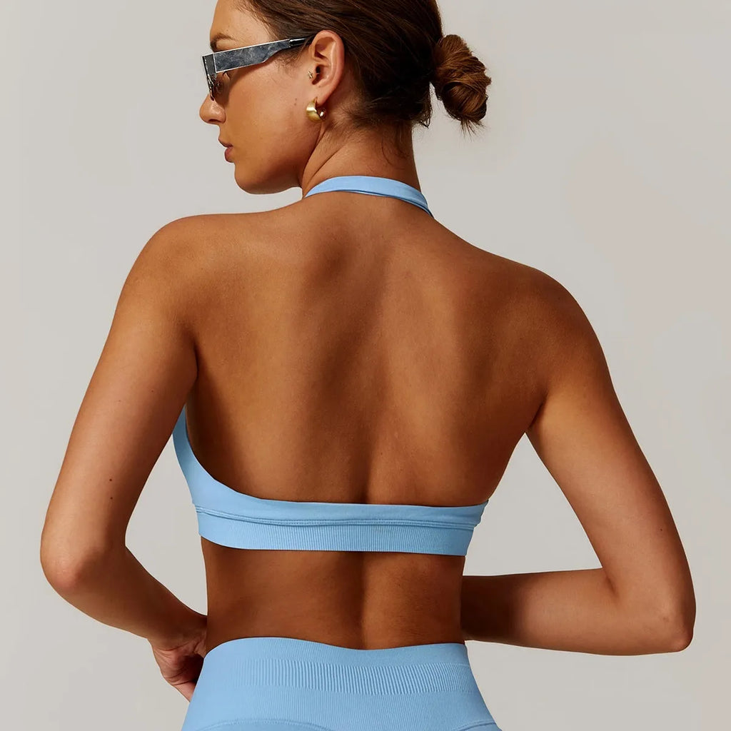 Women's halter neck yoga sports bra with removable pads in various colours.