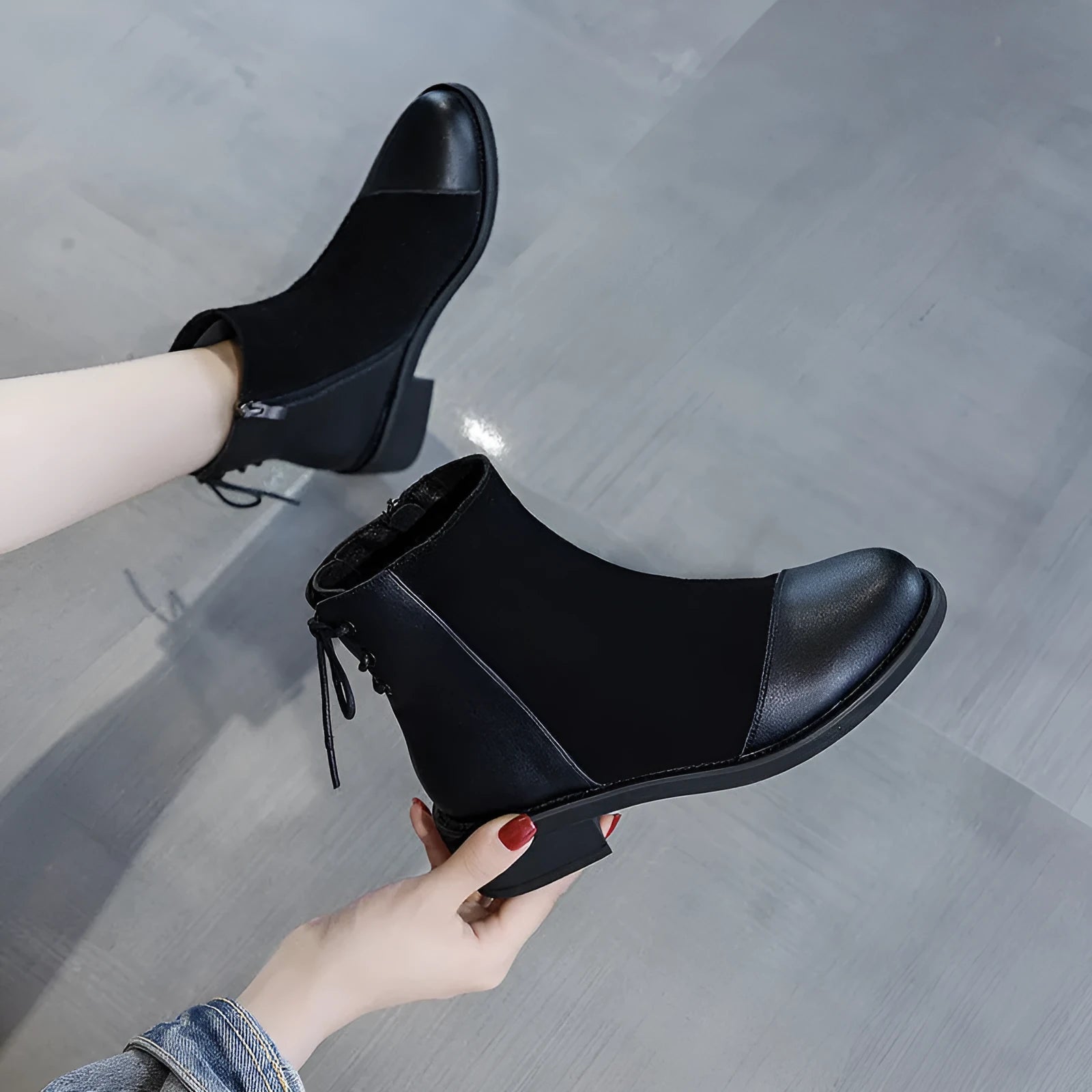 Black women's knee-high martin boots with a side zipper, round toe, and decorative bow.