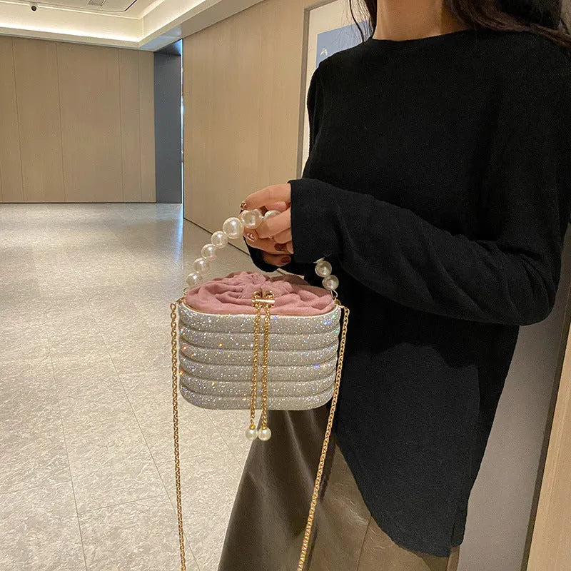 Women's retro style crossbody bag with pearl beads and rounded shape in soft PU material