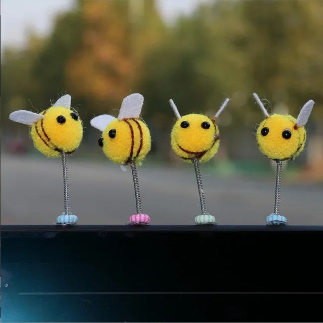 Swing spring bee car decoration made from soft fur ball, showing cartoon bee shape.