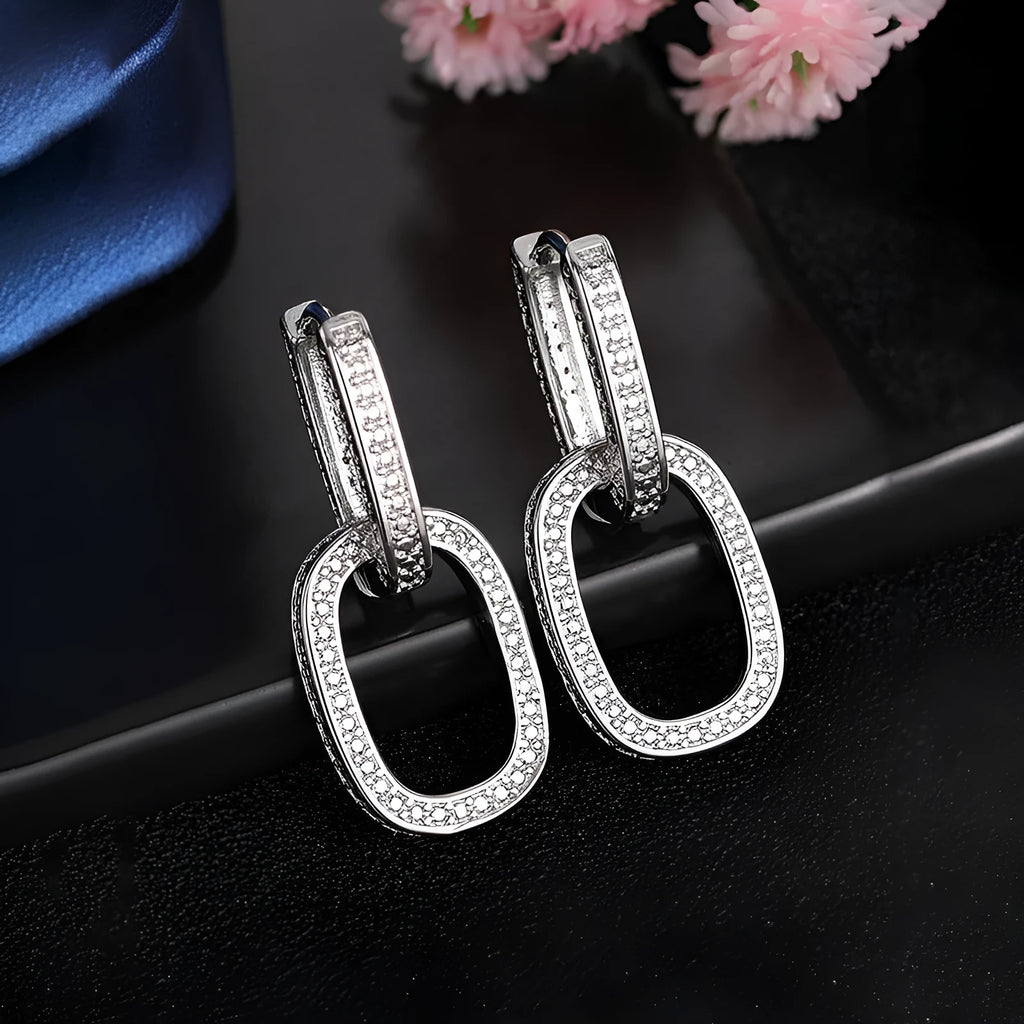 Pair of copper geometric U-shaped earrings with inlaid zircon in white gold colour