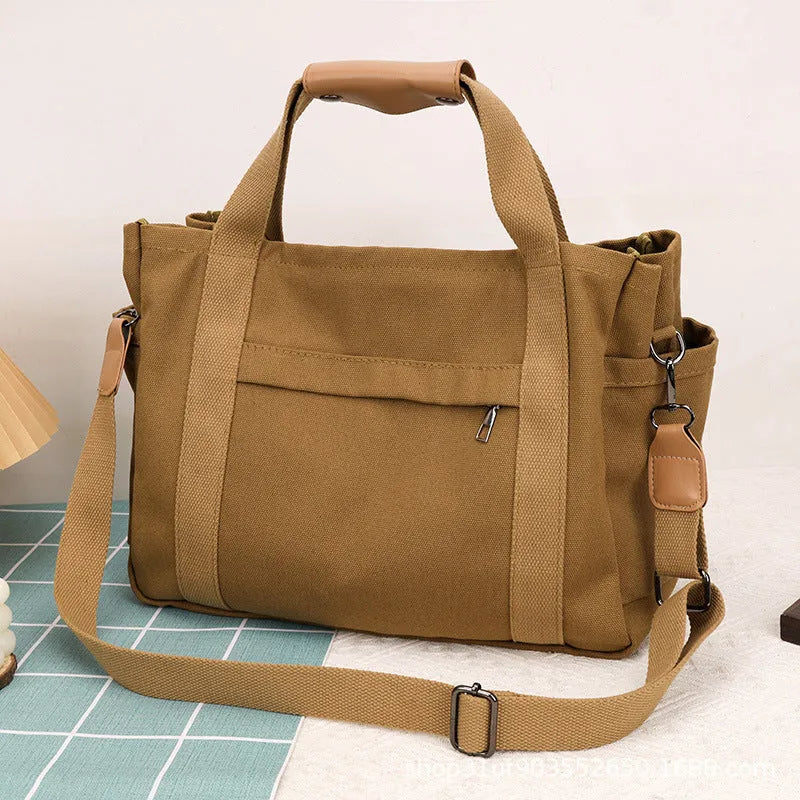 Canvas tote bag showing multiple internal compartments and both sides zipper openings in horizontal square shape