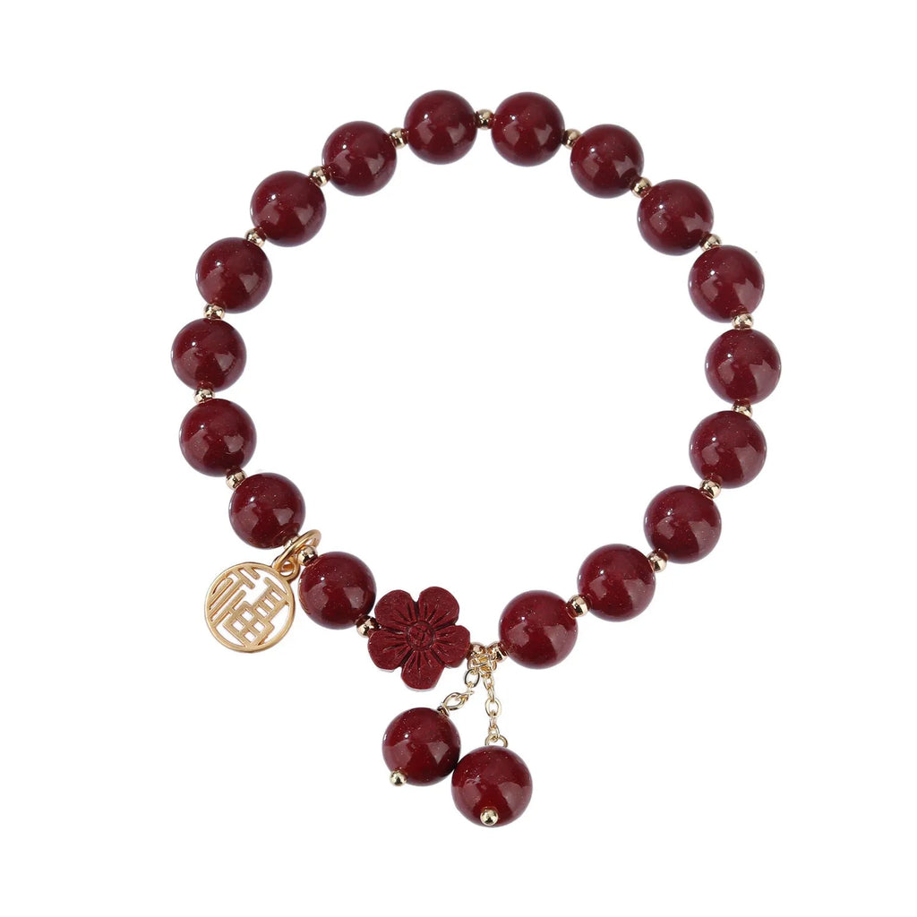 Traditional cinnabar women's bracelet with fu character centrepiece in purple and gold sand colours