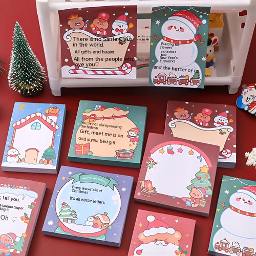 Christmas sticky notes pad showing eight festive designs including Santa Claus, elf, snowman, and gift box
