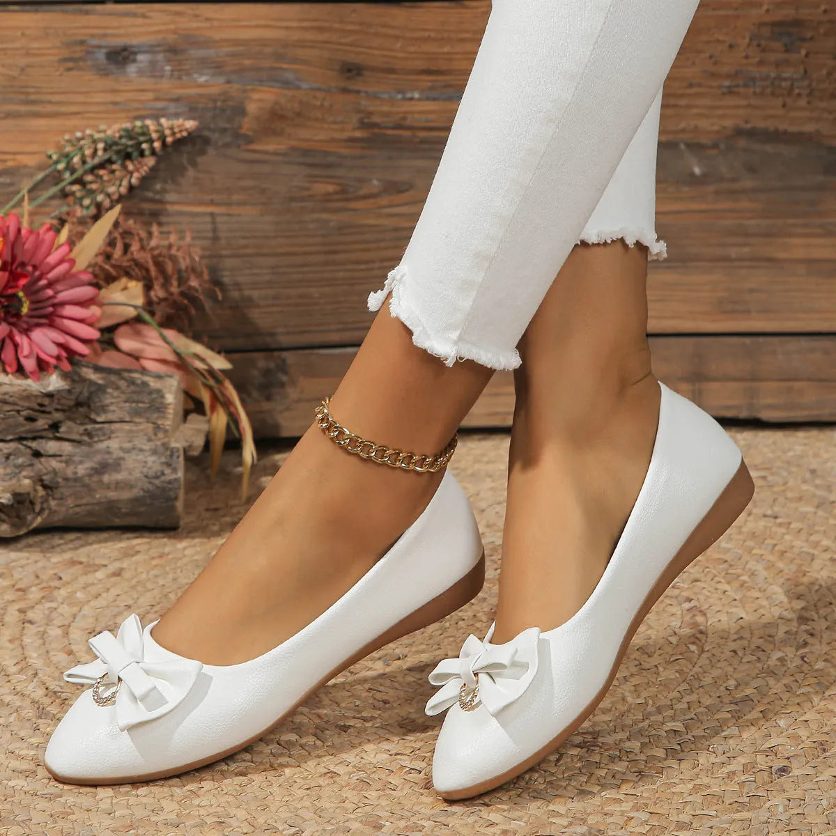 Women's beige flat casual slip-on shoes with a bowknot and shallow mouth design on a white background.