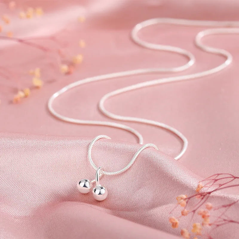 Silver cherry necklace for women with adjustable snake bone chain and Korean-style fruit pendant.