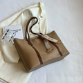 Women's soft large tote bag in a chosen colour, showing outer pockets and sewing detail.