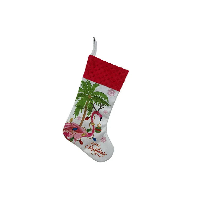 Red cloth Christmas stocking with flamingo design, 46cm long, hanging on fireplace.