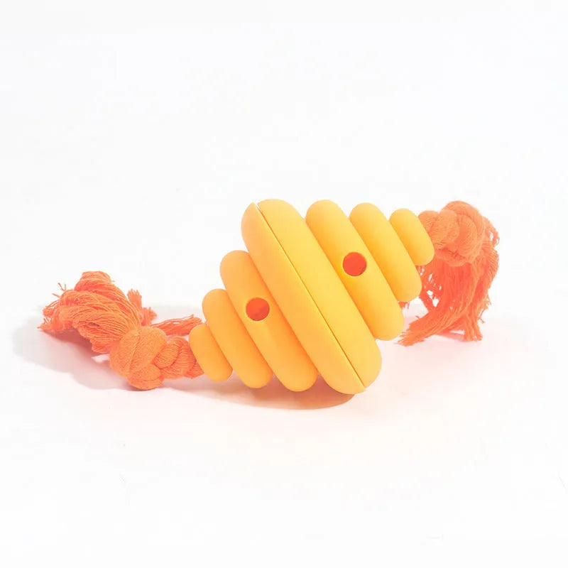 Green and yellow dog ball with attached rope for interactive play and food dispensing
