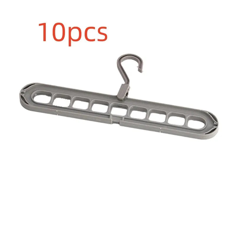 Green plastic nine-hole hanger folded flat showing multiple trouser hanging points