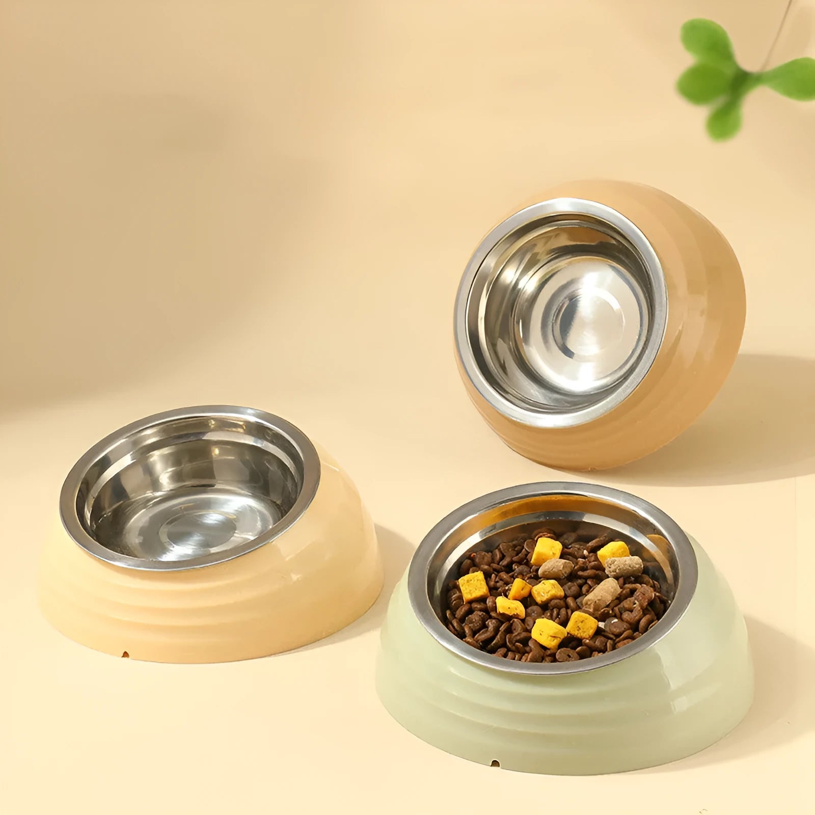 Stainless steel cat bowl on a plastic stand in light green, beige, or brown colour.