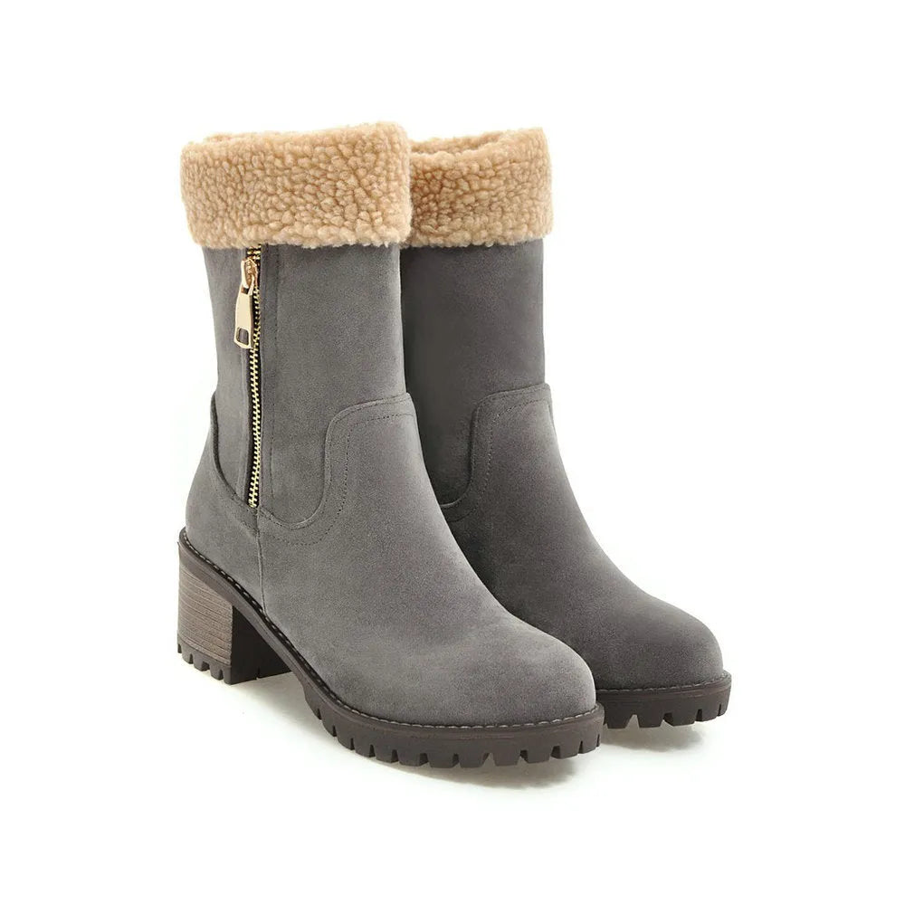 A pair of snow boots with a rubber sole and plush lining on a winter background.