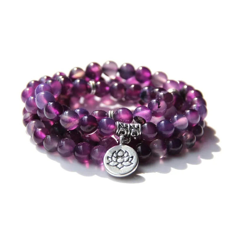 Vintage natural stone bracelet for women with a geometric lotus pendant on a model's wrist.