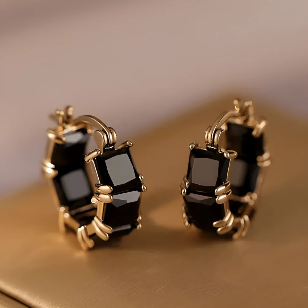 Geometric U-shaped gold earrings with black zircon crystal stones and round decorative elements
