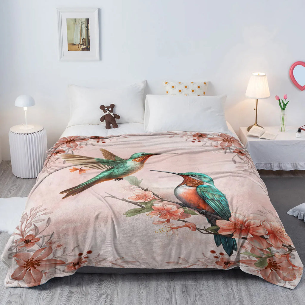 Pink hummingbird floral flannel velvet fleece throw blanket on sofa