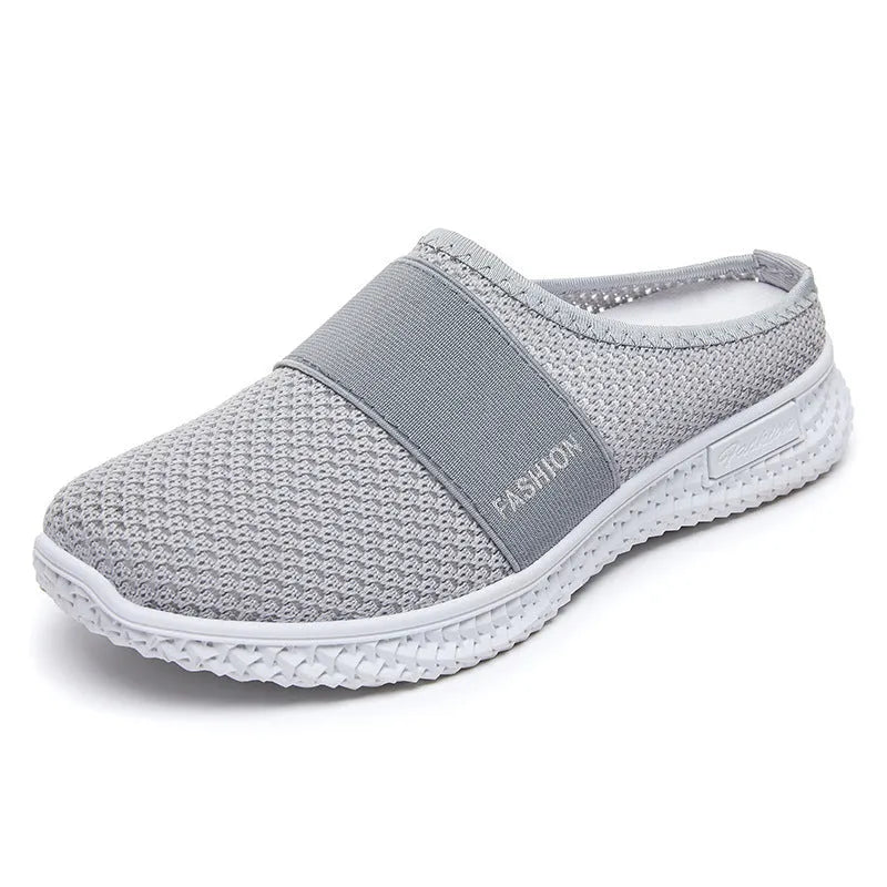 Women's casual breathable mesh shoes with hollow-out design and flat heel in black, gray, pink, or purple.