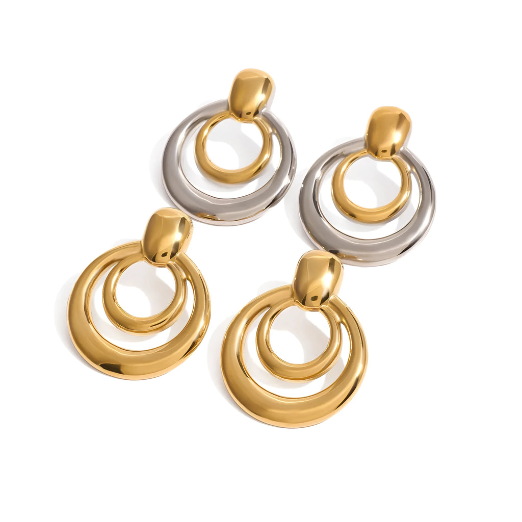Golden round double layer hollow stud earrings with geometric design on white background