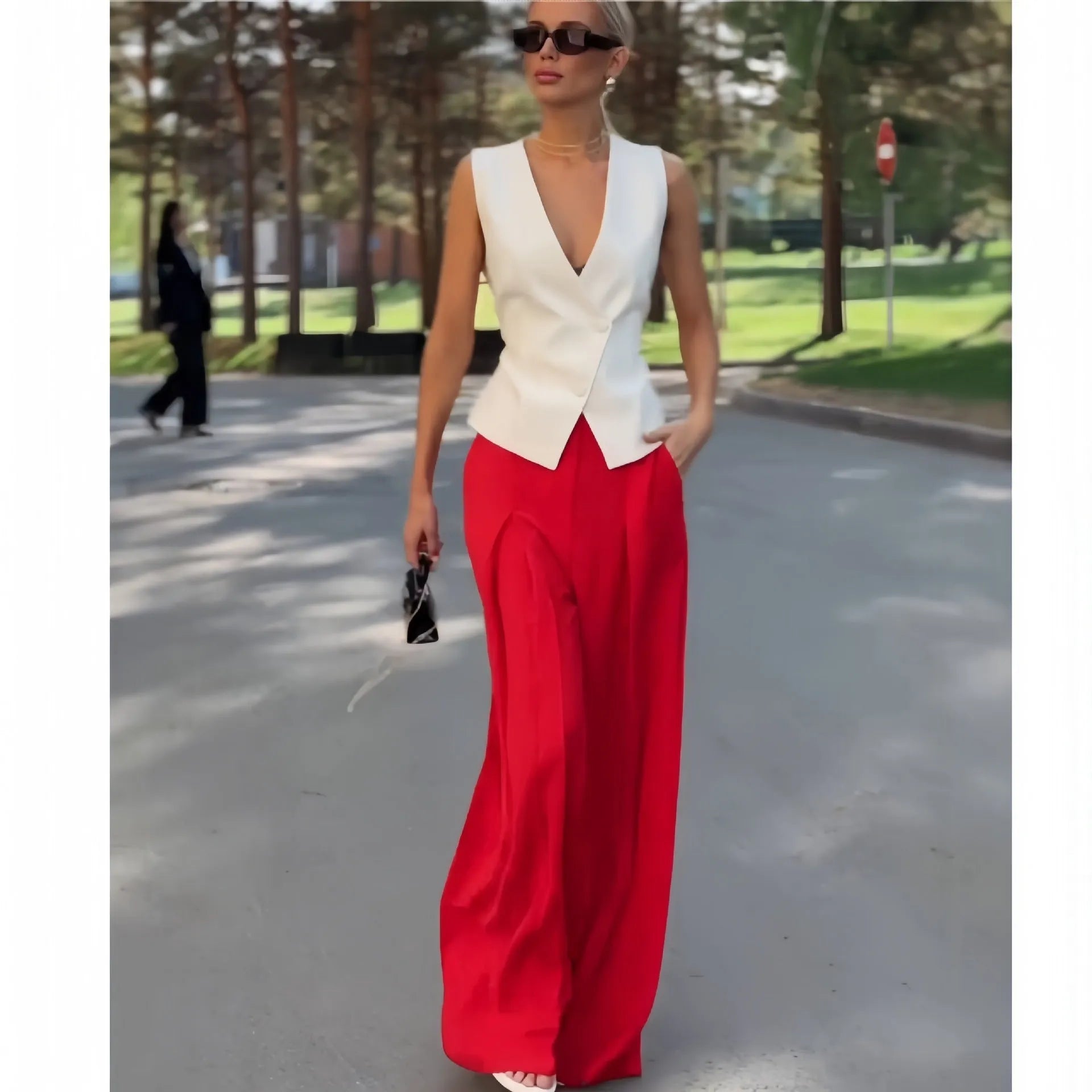 Beige women's two-piece set with deep V-neck sleeveless top and high-waist wide leg trousers
