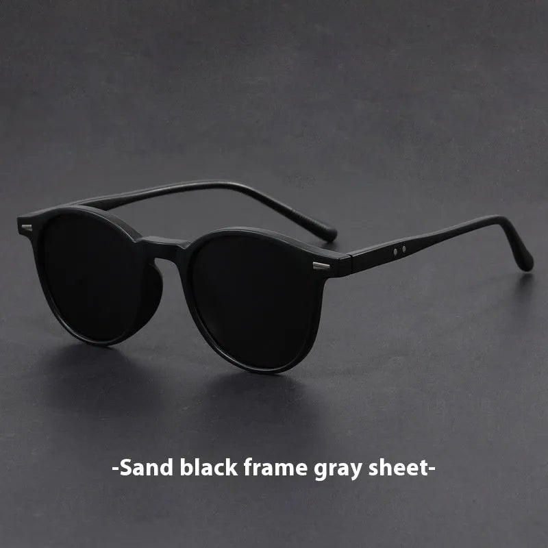 Retro oval sunglasses with ultra-lightweight round frame and polarised grey lenses.