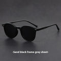 Retro oval sunglasses with ultra-lightweight round frame and polarised grey lenses.