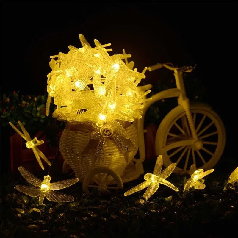 Outdoor solar LED string light with 30 warm white dragonfly lights and solar panel with ground spike