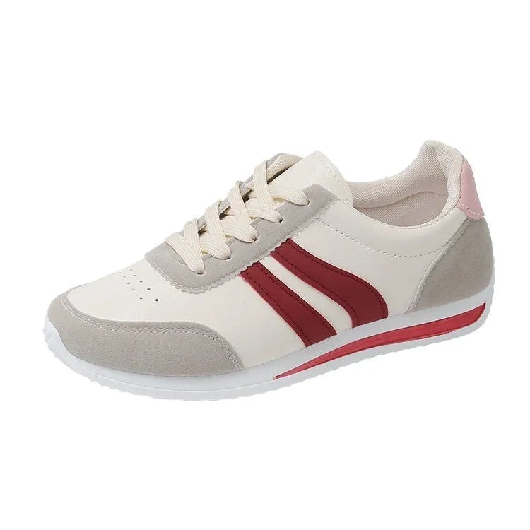 Red and blue lace-up low-top running sneakers with mesh upper and rubber sole on a white background.