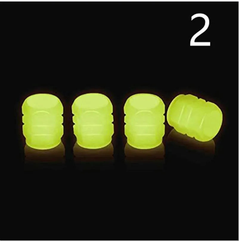 Pack of green and blue luminous rubber tyre valve caps on a car tyre valve.