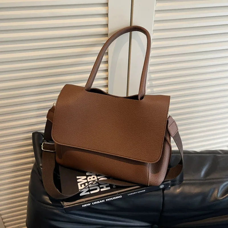 PU leather tote bag in beige with double shoulder strap and visible stitching detail.