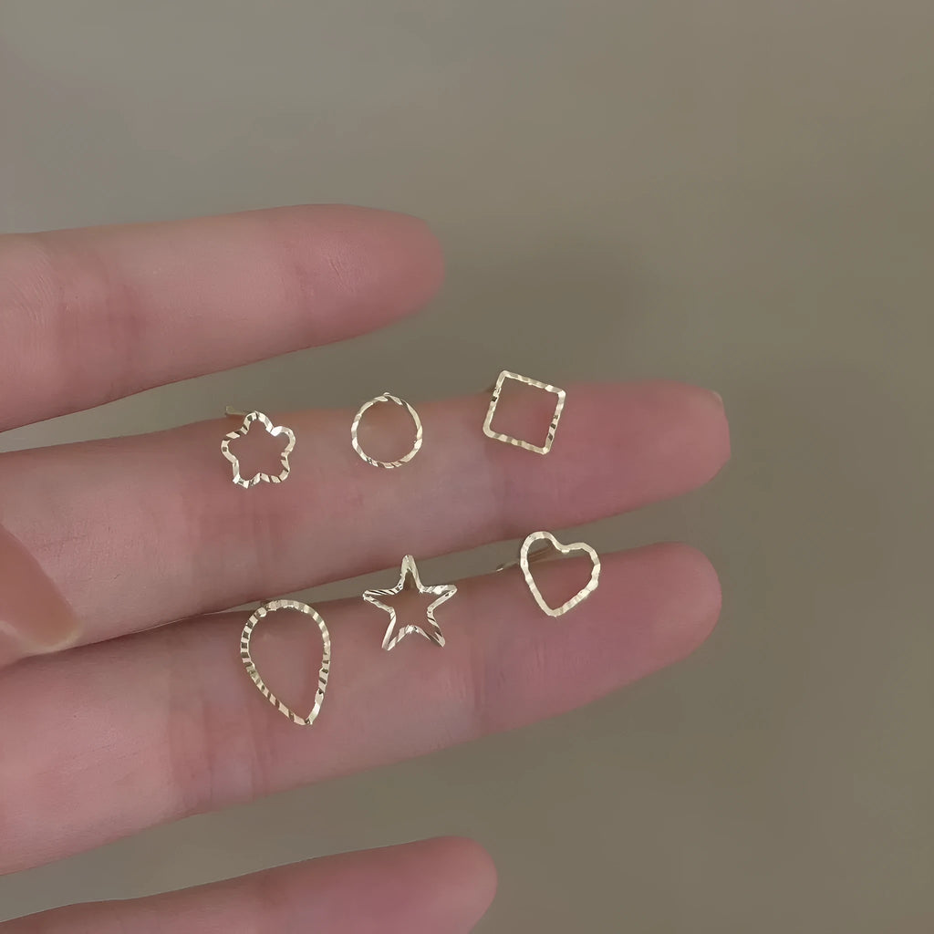 Small spiral geometric ear studs in gold hollow thread design with mixed material build and electroplated finish